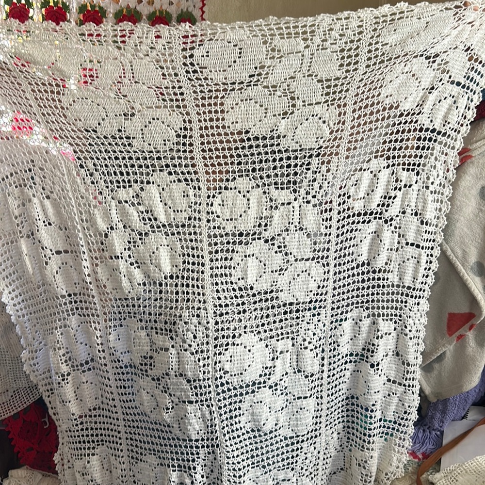 Hand made crochet table cloth of roses.